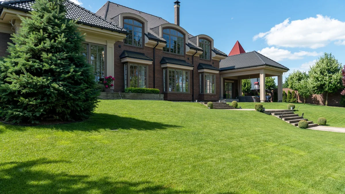 A large home in Saint Petersburg behind a wide, freshly mowed green lawn with clean edges